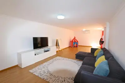 a living room with a couch and a flat screen tv at Villa Gustas 150 - Clever Details in Vilamoura