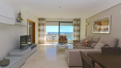a living room with a couch and a tv at Aquamar Sea View - Clever Details in Vilamoura