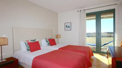 a bedroom with a bed and a large window at Aquamar Sea View - Clever Details in Vilamoura