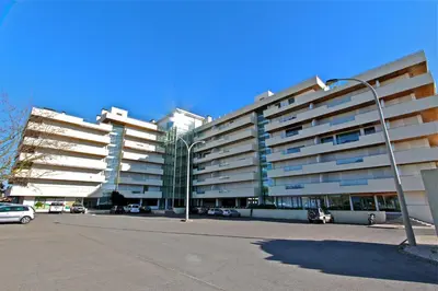 a large apartment building with cars parked in a parking lot at Aquamar Sea View - Clever Details in Vilamoura