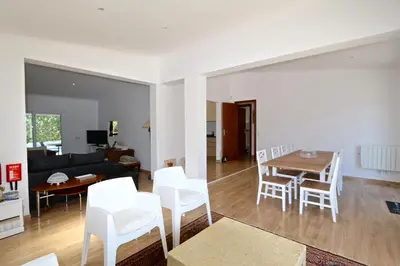 a living room and dining room with a table and chairs at Villa Caroline 3 - Clever Details in Vilamoura