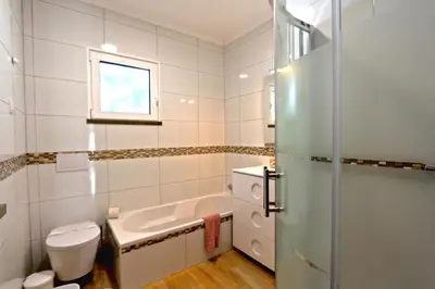 a bathroom with a tub and a toilet and a sink at Villa Caroline 3 - Clever Details in Vilamoura