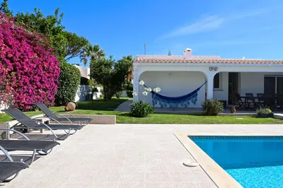 a villa with a swimming pool and a house at Villa Caroline 3 - Clever Details in Vilamoura