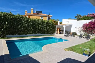 a swimming pool in the backyard of a house at Villa Caroline 3 - Clever Details in Vilamoura