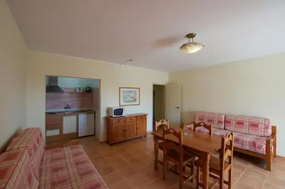 a living room with a table and a dining room at Mirachoro Albufeira in Albufeira