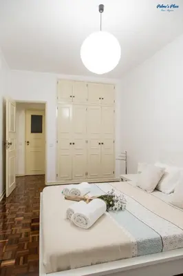 a white desk with a mirror and a chair at Palma's Place in Faro