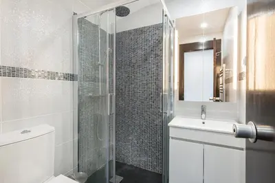 a bathroom with a shower and a toilet and a sink at Victory Village T1 & Mezzanine in Quinta do Lago