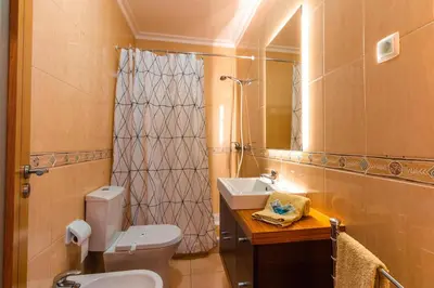 a bathroom with a toilet and a sink and a mirror at Sergio s Place - FARM VILLAGE - By Algarkasa in Albufeira