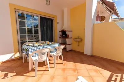a dining room with a table and chairs and a window at Sergio s Place - FARM VILLAGE - By Algarkasa in Albufeira