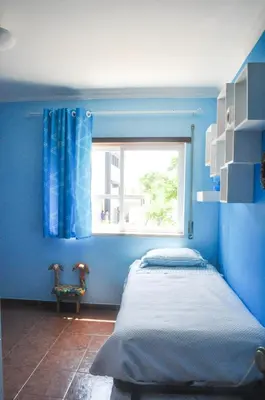 a blue bedroom with a bed and a window at Beach House in Vilamoura: Terrace+pool in Vilamoura