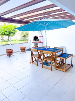 a bathroom with a blue shower curtain and a tub and sink at Beach House in Vilamoura: Terrace+pool in Vilamoura