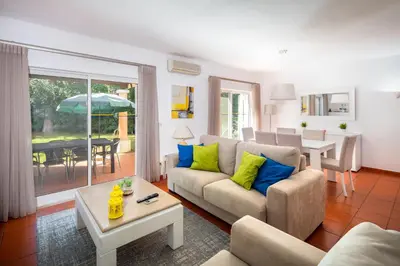 a living room with a couch and a table at Quinta Golf & Beach House in Quinta do Lago