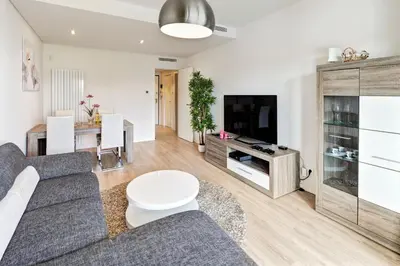 a living room with a couch and a tv at Luxurious T2 apartment, Olhos Dagua in Albufeira