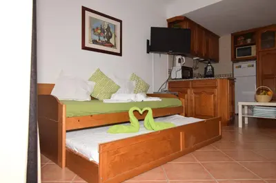 a bedroom with two beds with yellow towels on them at Casa Flor in Vilamoura