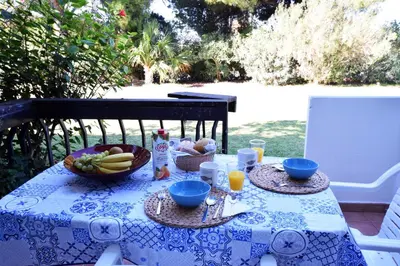 a blue and white table with a bowl of fruit on it at Casa Flor in Vilamoura