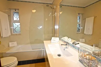 a bathroom with a sink and a tub and a toilet at Indico 154 - Clever Details in Vilamoura
