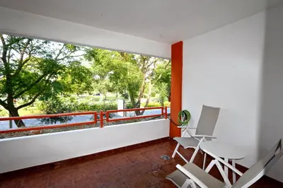 a room with a balcony with chairs and a large window at Indico 154 - Clever Details in Vilamoura