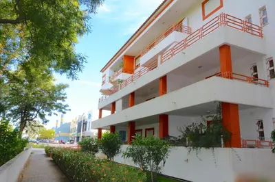 a white building with red balconies on a street at Indico 154 - Clever Details in Vilamoura