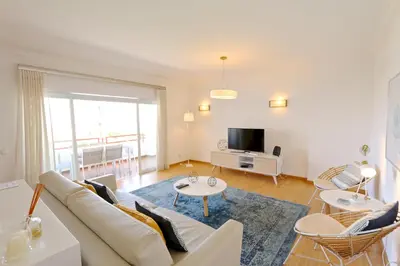 a living room with a couch and a tv at Indico 154 - Clever Details in Vilamoura