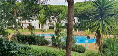 a resort with a pool and chairs and a building at Apt P209 situé au sein de Balaia Golf Village in Albufeira