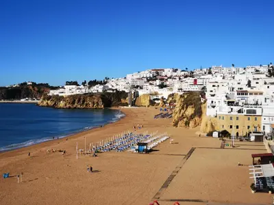 a view of a beach at night with lights at Apt P209 situé au sein de Balaia Golf Village in Albufeira