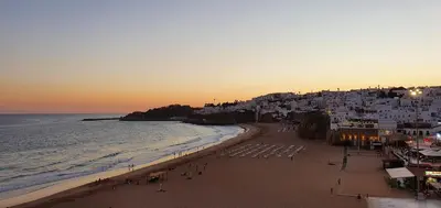 a rock pillar in the water with a boat at Apt P209 situé au sein de Balaia Golf Village in Albufeira
