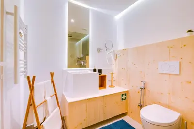 a bathroom with a toilet and a sink and a mirror at A Casa D'Amelie in Faro