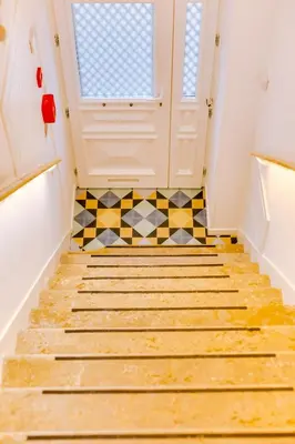 a hallway with a door and a tiled floor at A Casa D'Amelie in Faro