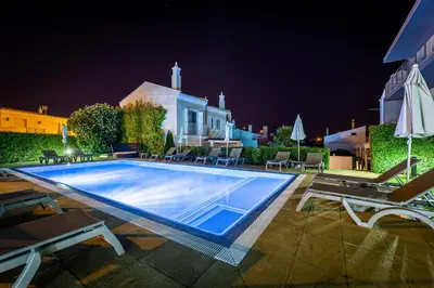 a swimming pool in the middle of a building at night at Boutique & Villas Boliqueime in Boliqueime