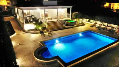 an overhead view of a swimming pool at night at Sunset Villa by Laranjal Rentals in Olhos de Água
