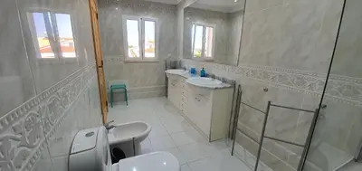 a bathroom with two sinks and a shower at Sunset Villa by Laranjal Rentals in Olhos de Água