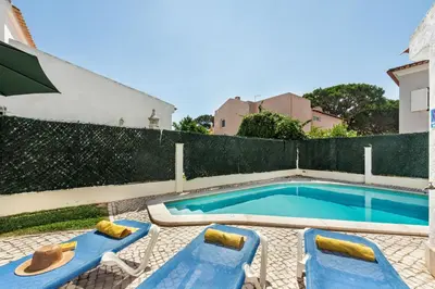 a bedroom with two beds and a large window at Residential cul-de-sac walking distance to centre, private pool, free AC wifi in Loulé