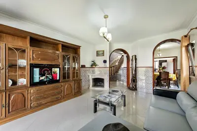 a kitchen with a table with a bowl of fruit on it at Residential cul-de-sac walking distance to centre, private pool, free AC wifi in Loulé