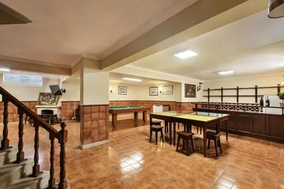 a dining room with a table with a yellow table cloth at Residential cul-de-sac walking distance to centre, private pool, free AC wifi in Loulé