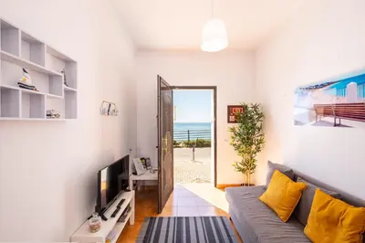 a living room with a couch and a view of the ocean at #003 Cottage By Home Holidays in Albufeira
