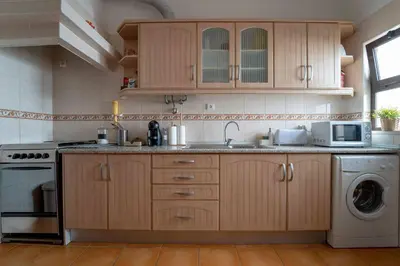 a kitchen with a sink and a dishwasher at #003 Cottage By Home Holidays in Albufeira