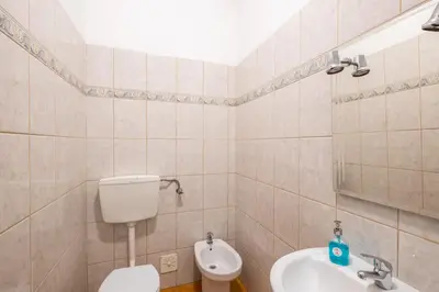a bathroom with a toilet and a sink at #003 Cottage By Home Holidays in Albufeira