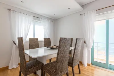 a dining room with a white table and chairs at SeaShell Apartment by Atlantic Places in Albufeira