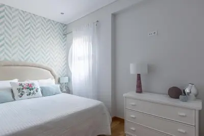 a bedroom with a white bed and a white dresser at SeaShell Apartment by Atlantic Places in Albufeira