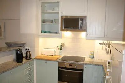 a kitchen with white cabinets and a stove top oven at Seastar in Vilamoura