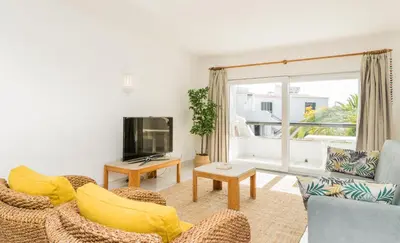 a living room with two chairs and a tv at Great S.Rafael Aprt. walking distance to the beach in Albufeira