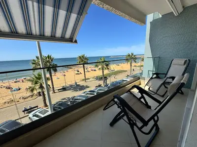 a balcony with two chairs and a view of the beach at Brisa do Mar - 2BR Sea Front Luxury Apartment in Quarteira
