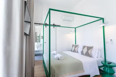 a bedroom with a four poster bed with a glass canopy at Alameda Exclusive House in Faro