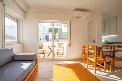 a living room with a couch and a table at Edifício Sequeira - Alojamento Local by Umbral in Albufeira