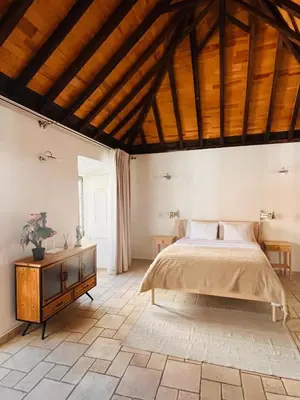 a bedroom with two beds and a table in a room at Faro Town House in Faro