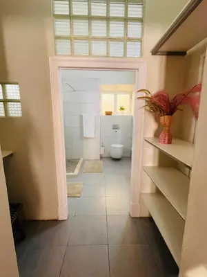 a bathroom with a toilet and a window at Faro Town House in Faro