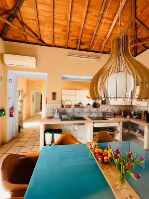 a wooden table and chairs with an umbrella on a patio at Faro Town House in Faro