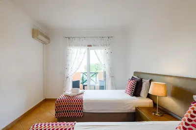 a bedroom with two beds and a window at Quinta do Paiva - Jardins do Vale in Roja- Pé