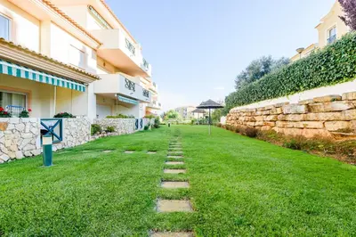 a walkway in the grass next to a building at Quinta do Paiva - Jardins do Vale in Roja- Pé