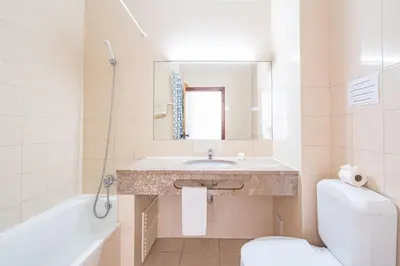 a bathroom with a sink and a tub and a toilet at Eirasol by Umbral in Albufeira